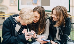 Teenagers looking at a smartphone