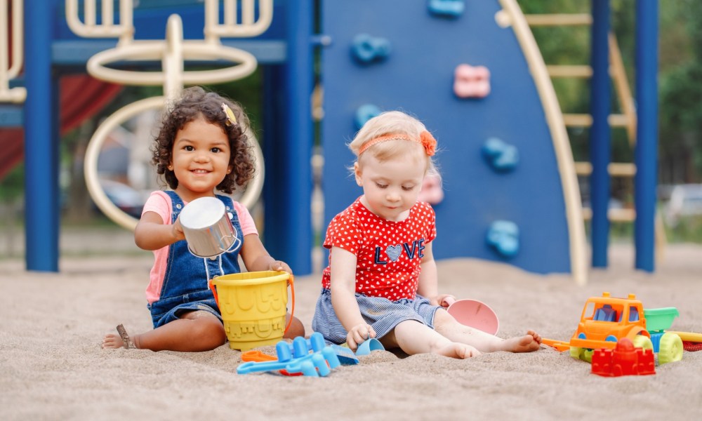 Two little girls playing at a playground