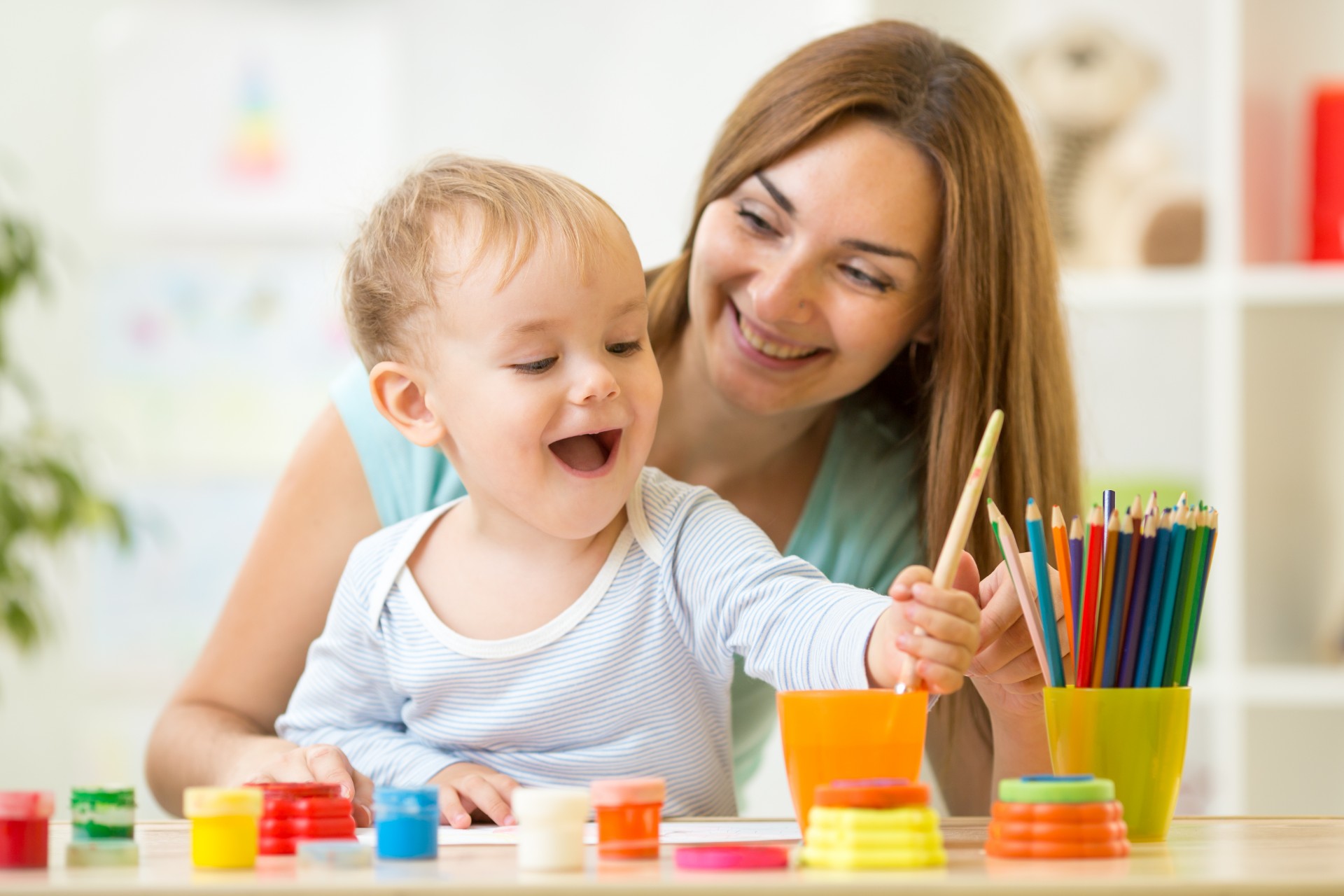 Mother with child using art supplies