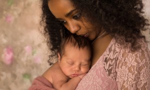 Woman kissing her sleeping baby