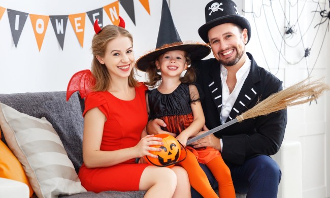 Mother and father with daughter in Halloween costumes