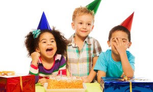 Three kids celebrating a birthday party