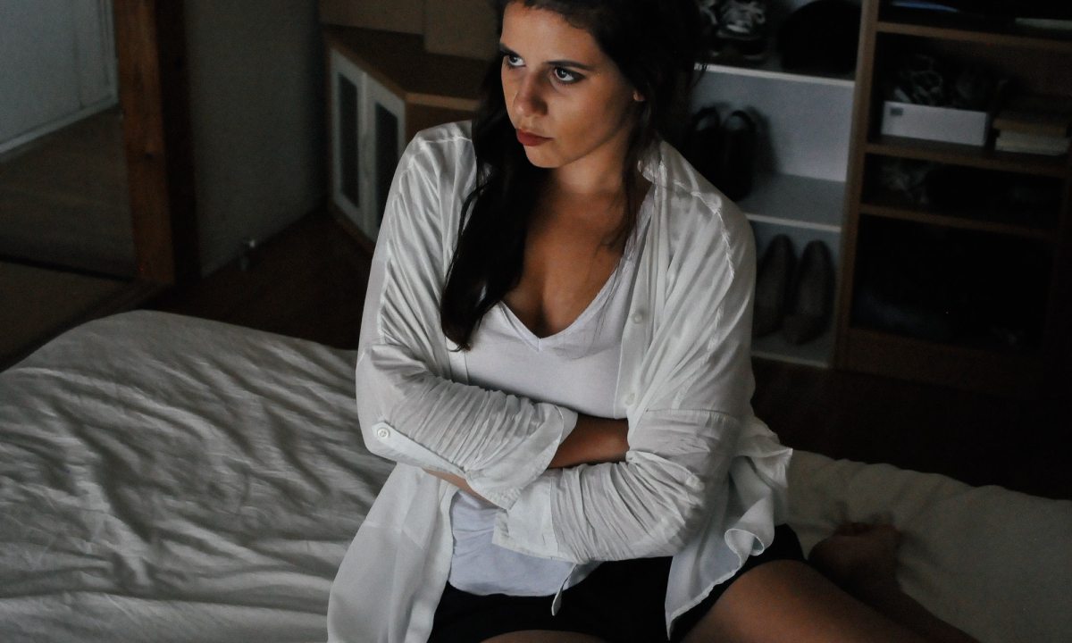 teenage girl with arms crossed in bedroom