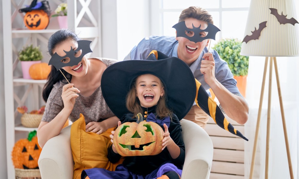 Family of three celebrating Halloween