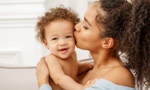 Mother kissing her baby