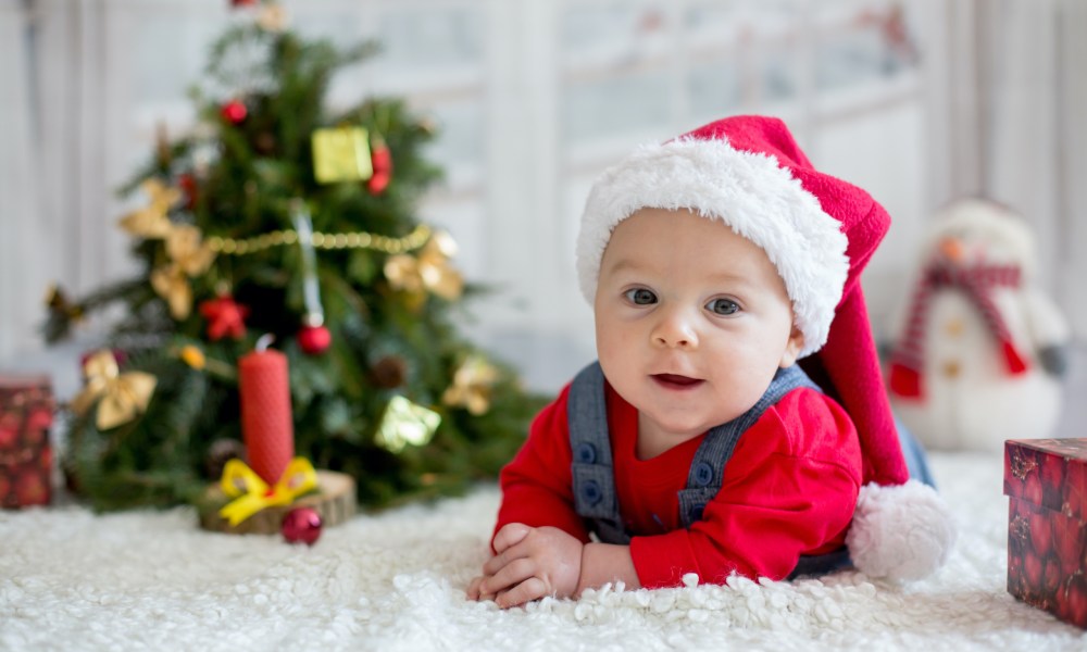 Baby in front of a Christmas tree