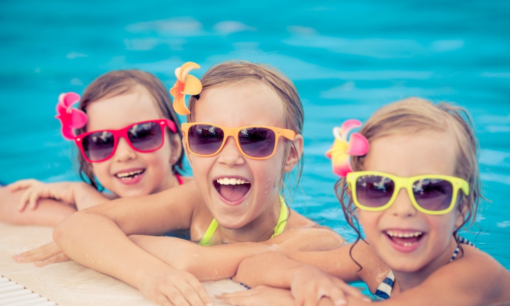 Kids with sunglasses in a pool