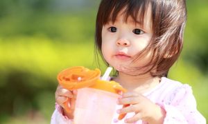 A girl with a sippy cup