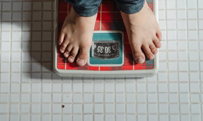 Standing on a weight scale