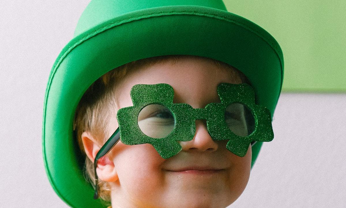 Toddler wearing shamrock glasses and hat