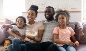 Family on couch watching TV