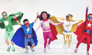 A group of kids dressed in superhero costumes