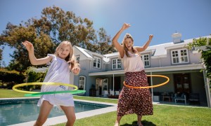 A mom and daughter having fun with hula hoops