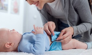 A mom making a cloth diaper change on a baby