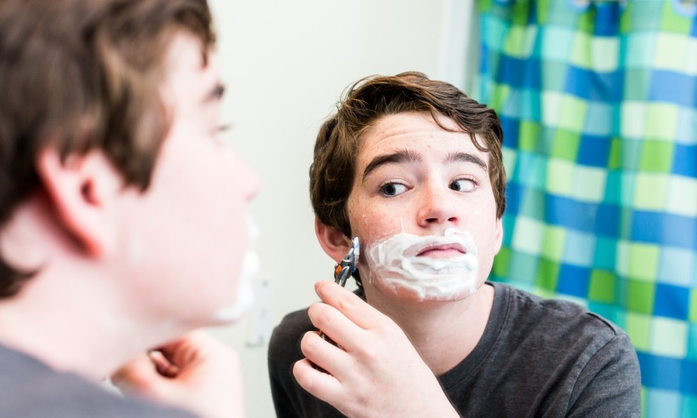 Teen boy shaving