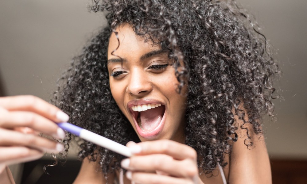 Woman excited at pregnancy test