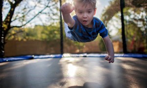 Boy playing on a trampoline