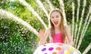 Girl laying with a sprinkler