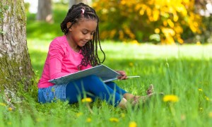 Girl reading under tree