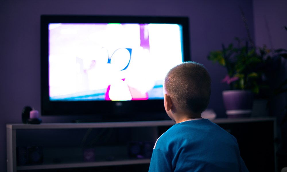 Child sitting in front of the TV