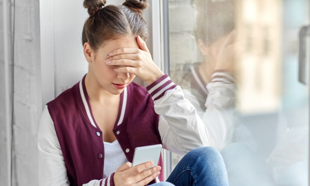 Upset teenage girl on a cellphone