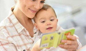 Baby reading with parent