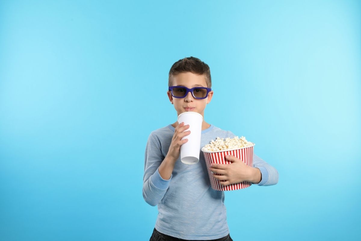 young boy getting ready to watch a move