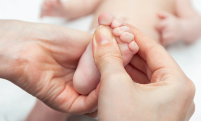 Parent rubbing baby feet