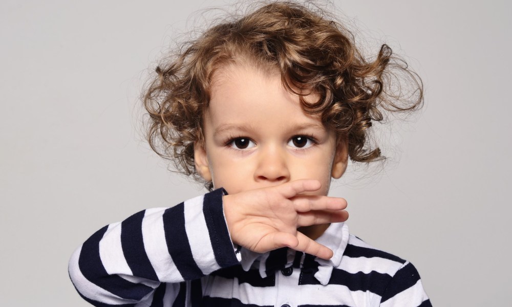 Toddler sucking on the back of their hand