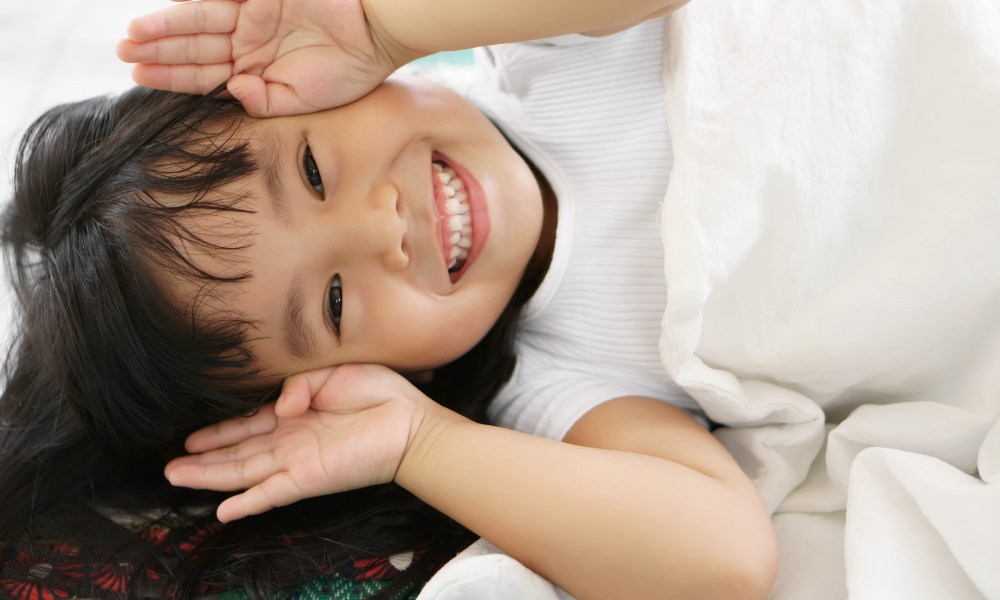 Toddler playing peekaboo