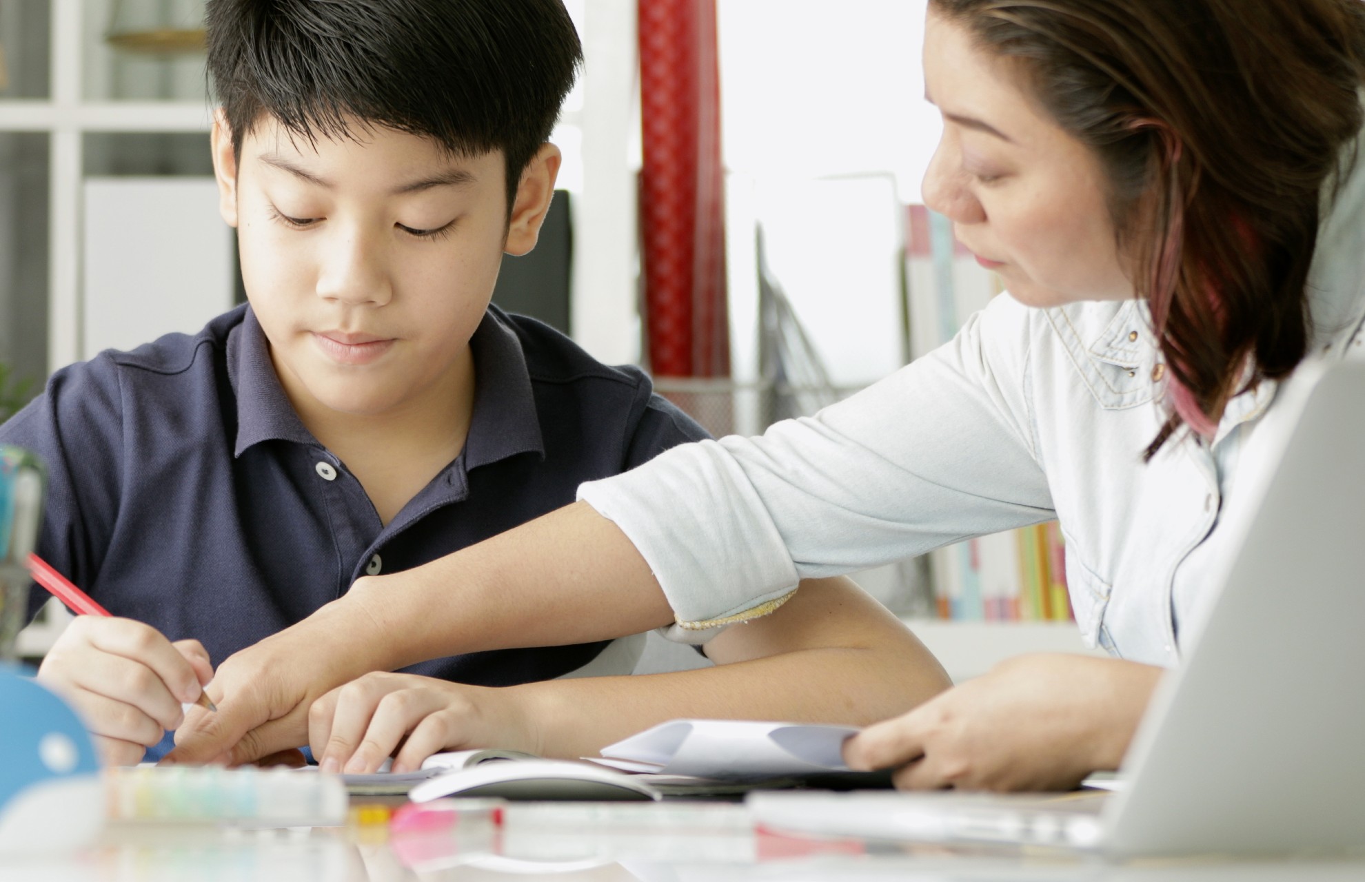 Mom and teen boy doing homework