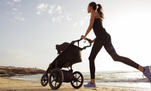 Mom exercising with her baby in a stroller.