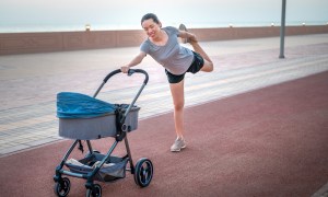 A mom working out while pushing her baby in a stroller