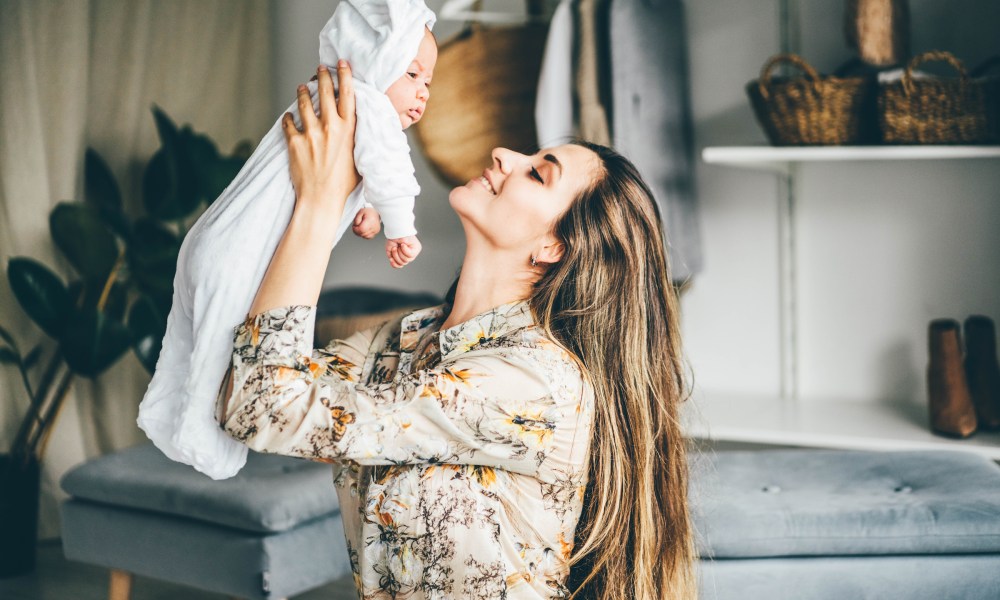 Woman with long hair holding baby