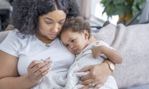 A parent taking care of a sick child.