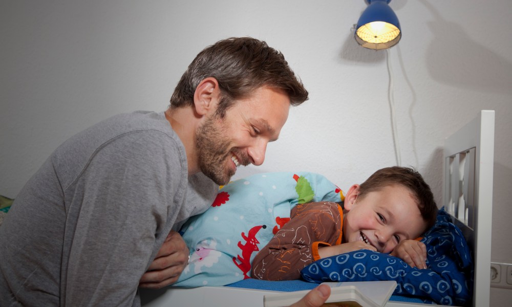 Dad reading to child.