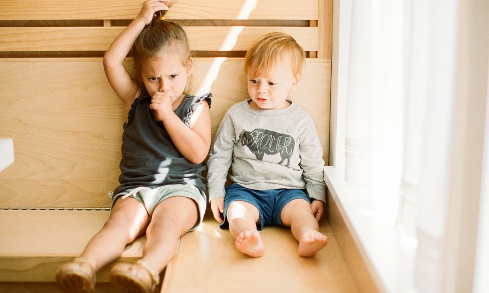 Toddler pulling her hair and sucking her thumb.