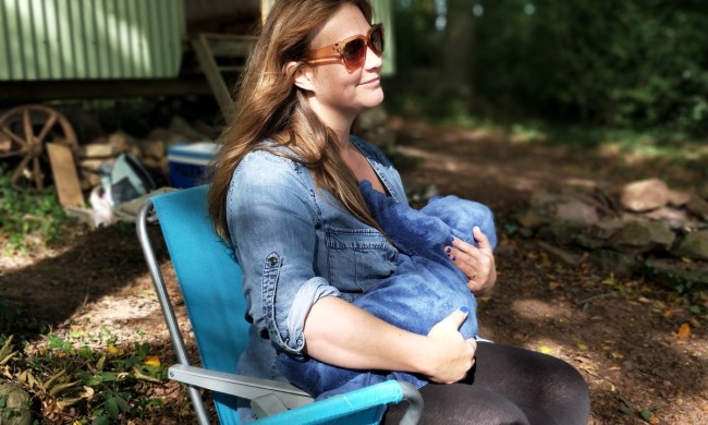 Woman breastfeeding older infant outside