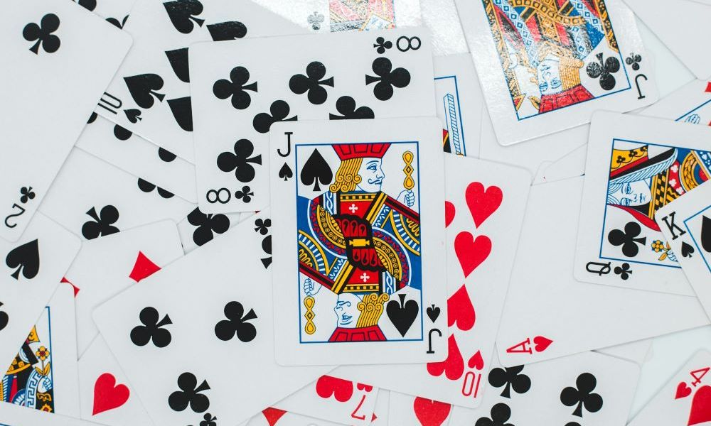 deck of cards scattered on a table