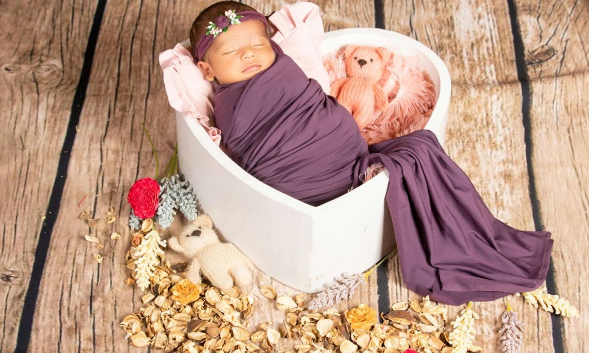 baby asleep in a heart-shaped box