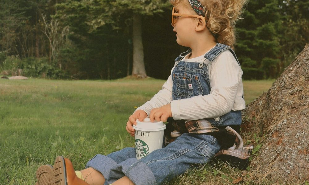 A girl outside with a Starbucks drink.