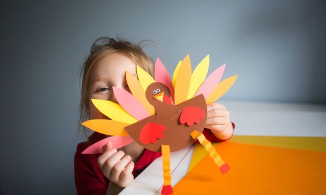 Little girl showing off her Thanksgiving turkey craft