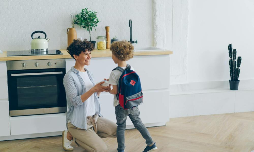 A parent and child getting ready to leave for school.