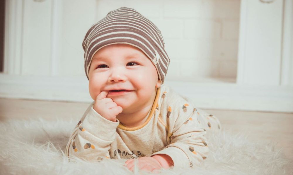 cute baby boy chewing on his finger