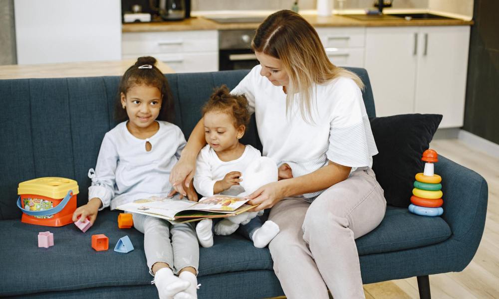 A caretaker reading children a story