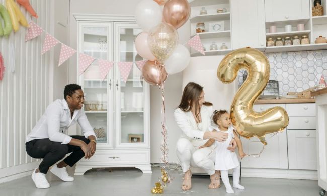 Happy family celebrating their two-year-old's birthday