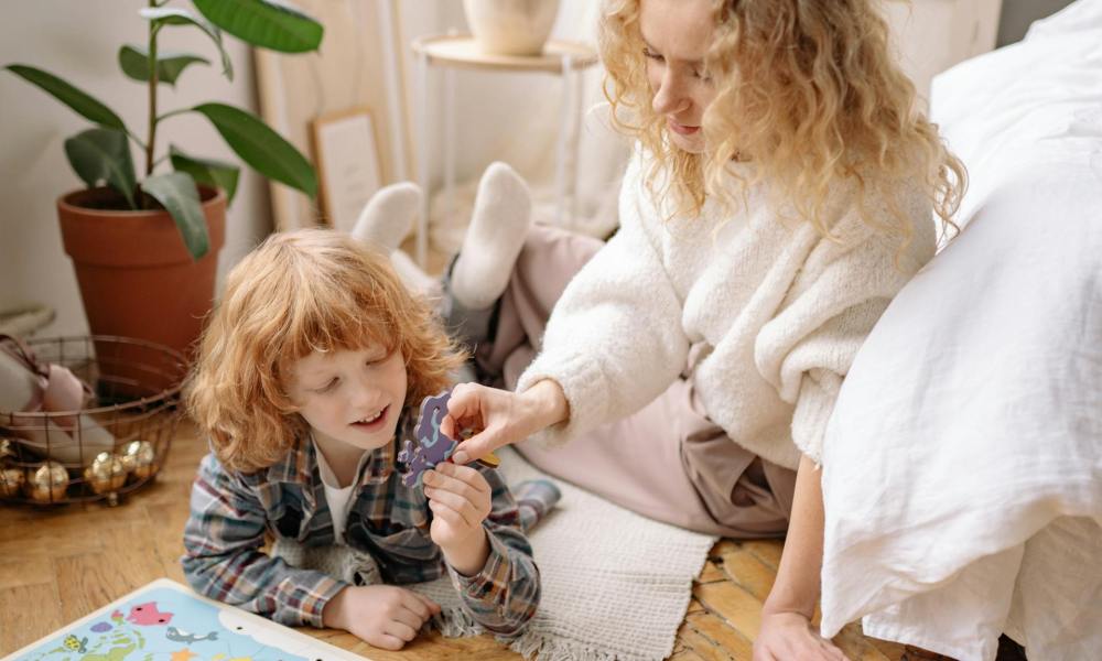 Child and parent playing with a puzzle